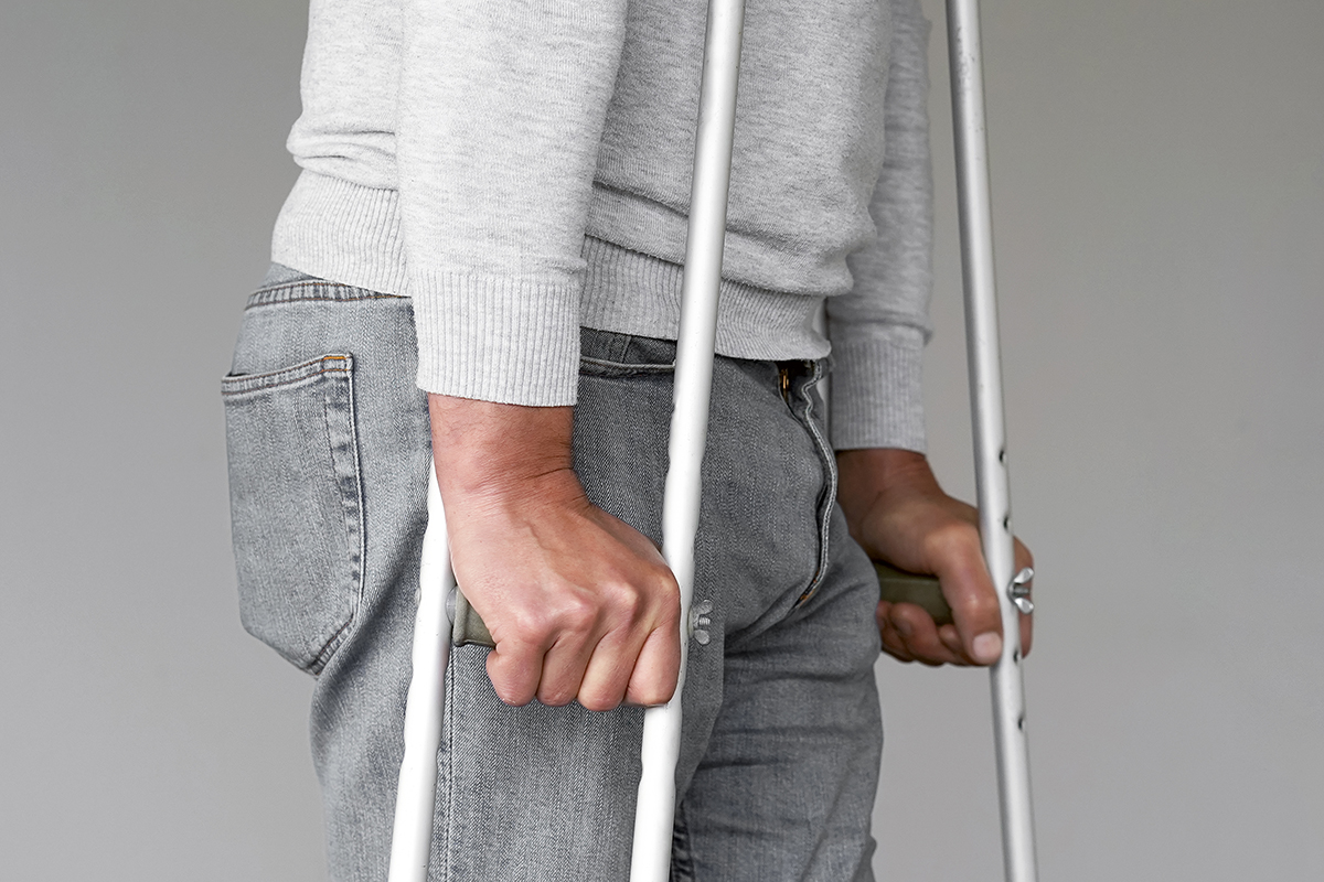 man-with-crutch-close-up-side-view.jpg